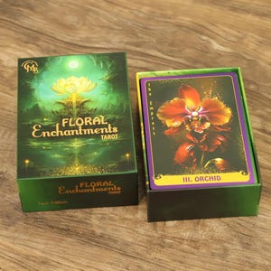 Close up of the Floral Enchantments Tarot gift box with a golden lotus design on a rich green background.