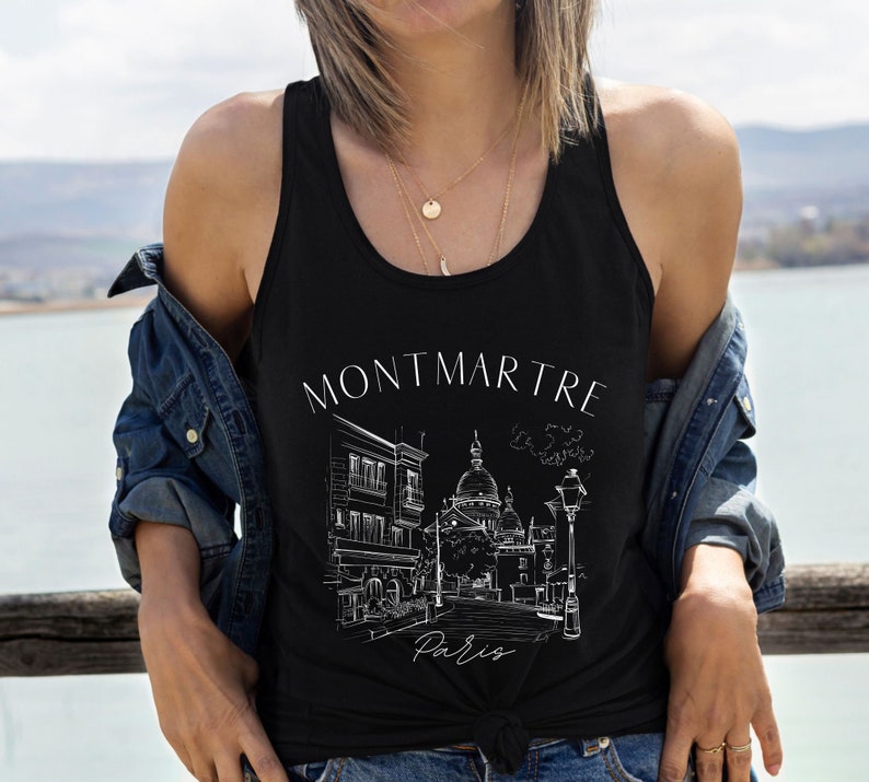 May include: Black tank top with a white graphic of a Parisian street scene with the text "Montmartre Paris".