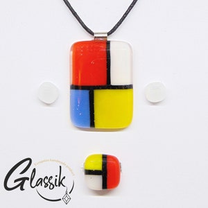 May include: A geometric glass pendant necklace with red, yellow, blue, white, and black squares. The necklace is on a black cord and has a silver clasp. The pendant is approximately 2 inches tall and 1 inch wide.