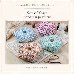May include: Four biscornu patterns in blue, pink, green, and gold geometric designs are shown. Each pattern is square-shaped with a button in the centre. The text reads "ALBUM DE BRODERIES" and "Set of four biscornu patterns". The bottom text reads "Atelier PIN & NEEDLE".