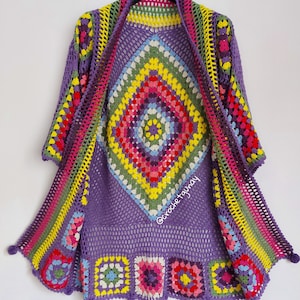 May include: A purple crochet cardigan with a colorful granny square design. The cardigan has a wide, open front and a loose fit. The sleeves are three-quarter length and the cardigan is finished with a fringe trim.