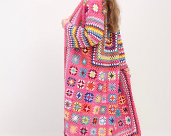 May include: A long pink crochet cardigan with colorful granny squares and fringe trim.