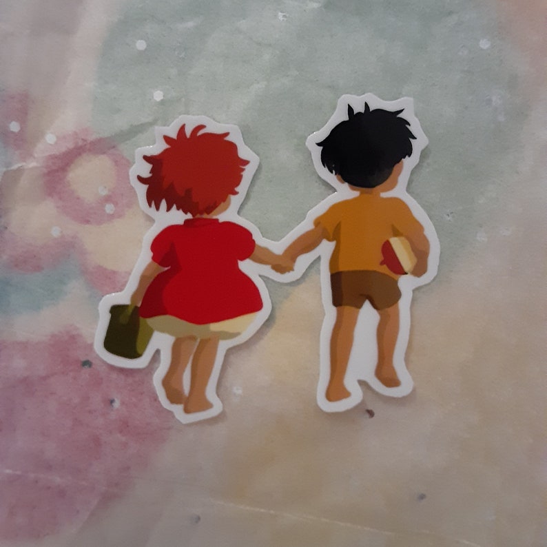 May include: A sticker featuring two children walking hand-in-hand. The girl has red hair and is wearing a red dress. The boy has black hair and is wearing a yellow shirt and brown shorts. He is holding a red and white ball.