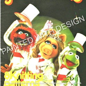 May include: A vintage book cover featuring the Muppets characters, Kermit the Frog, Miss Piggy, and Animal, in formal attire. The cover is titled "Jim Henson's Muppets 8 Knitting Patterns".