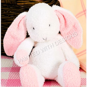 May include: A white plush bunny with pink ears and feet. The bunny is sitting on a pink and white checked blanket.