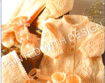 May include: A peach-colored knitted baby set, including a jacket, bonnet, booties, and mittens, all with a delicate leaf pattern. The set is tied with peach ribbons. The text "PAINTED WITH DESIGN" is visible.
