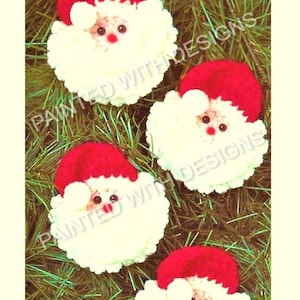 May include: Four handmade felt ornaments shaped like Santa Claus. Each ornament has a red hat, white beard, and black eyes. The ornaments are displayed against a green background.