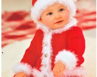 May include: A red knitted long-sleeve outfit with white fuzzy trim along the cuffs, hem, and front button placket. The outfit includes a matching red knitted hat with a white fuzzy brim and a white pom-pom on top, featuring four visible buttons.
