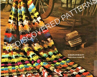 May include: A crocheted blanket featuring a repeating pattern of small animal silhouettes in vibrant colors including yellow, orange, red, blue, and black. The blanket has a long white fringe along the bottom edge and includes the text SCRAPS OF BEAUTY.