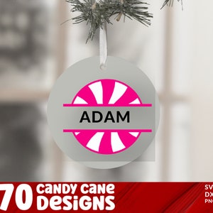 May include: A white circle ornament with a pink and white candy cane design and the name "ADAM" in black text.
