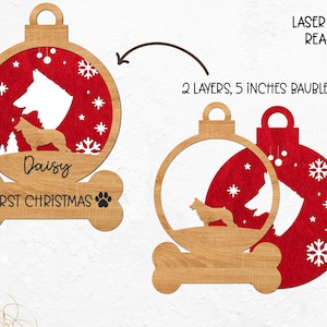 May include: Laser cut ready, two-layer, 5-inch Christmas ornament with a red and white snowflake design. The ornament features a silhouette of two dogs inside a circle with the text "Daisy First Christmas" on a bone-shaped base.