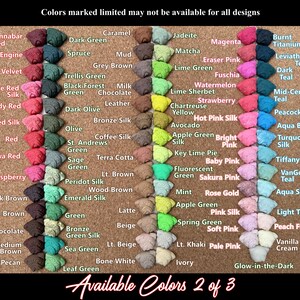 May include: A color chart with various fabric swatches, each labeled with a unique color name. The chart includes a wide range of hues, from reds and pinks to greens and blues, with text that reads "Available Colors 2 of 3."