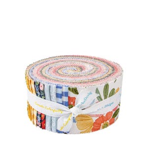 May include: A roll of colorful fabric strips, tightly wound and secured with a white ribbon. The fabric features floral and patterned designs in shades of pink, blue, yellow, and green. The ribbon reads "Create Colorfully" and "Lake Design".