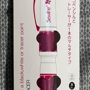 May include: Sewline Trio fabric pencil in a package. The pencil is white and magenta with a black, white, and tracer point. The package includes text in English and Japanese.