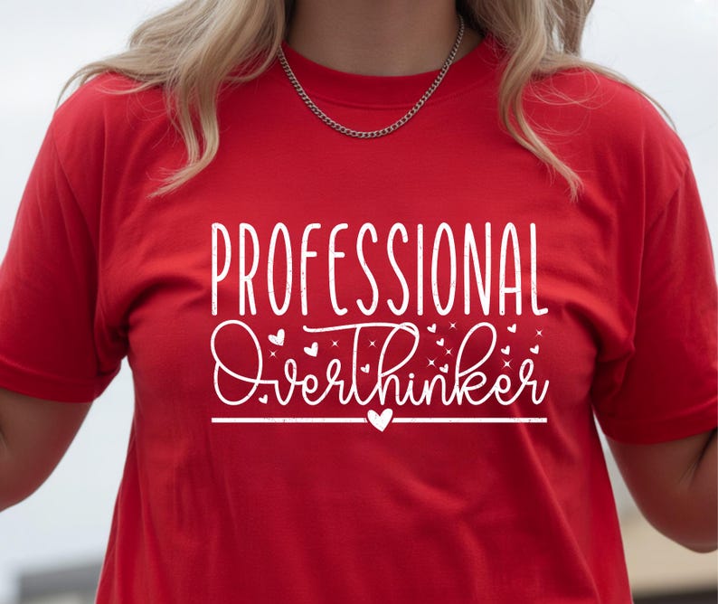 A person wearing a red t-shirt with the text "Professional Overthinker" printed on it.
