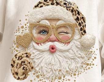 May include: White sweatshirt featuring a whimsical Santa Claus design. Santa is depicted with a winking eye, gold-rimmed glasses, and a leopard print hat and mitten. The design includes gold accents and the text "PNG Digital download".
