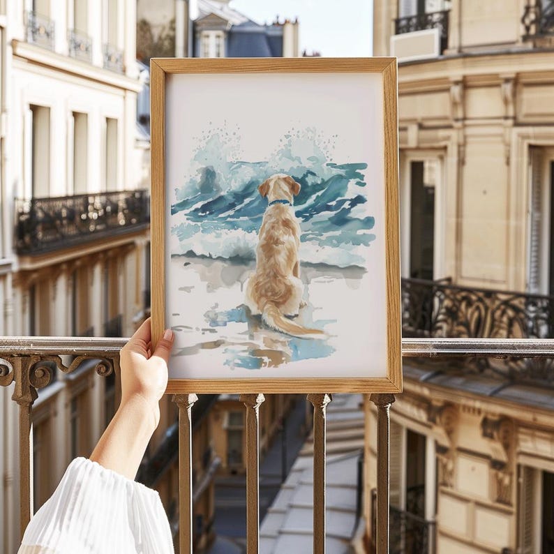 May include: A watercolor painting of a golden retriever dog sitting on a beach, looking out at the ocean waves. The dog is wearing a blue collar and the waves are crashing in the background.