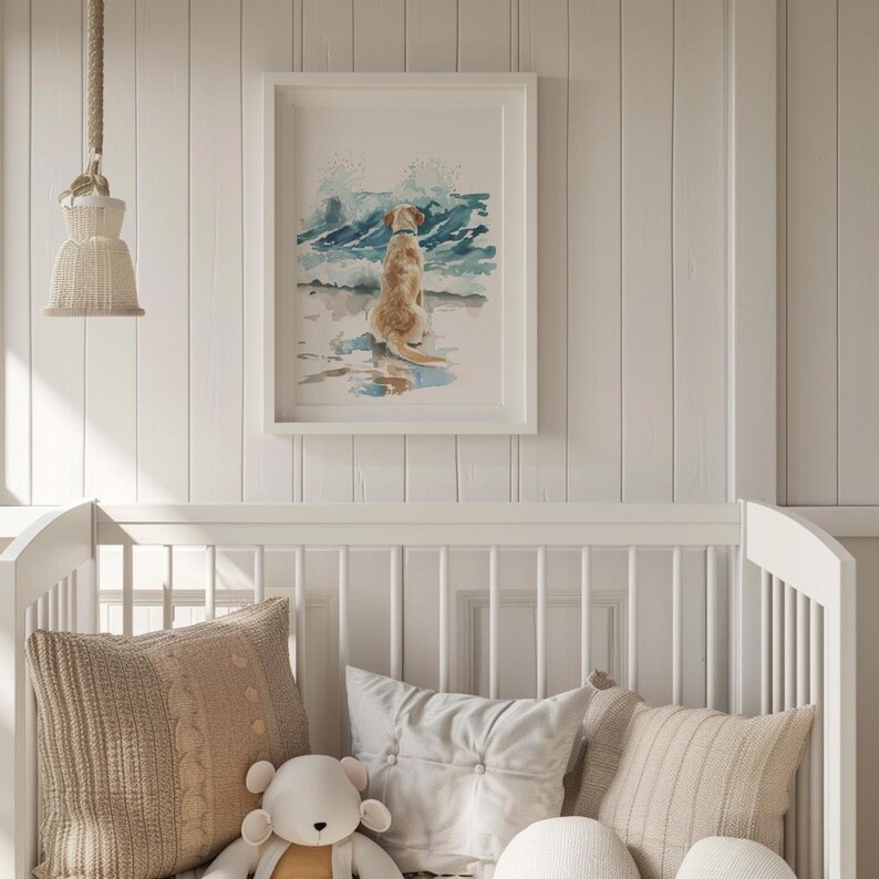 May include: A white framed watercolor painting of a golden retriever dog sitting on a beach with blue waves crashing behind it.