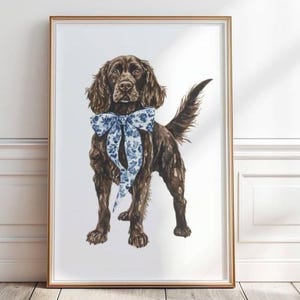 May include: A watercolour painting of a brown and black dog wearing a blue and white floral bow. The dog is standing on a white background.