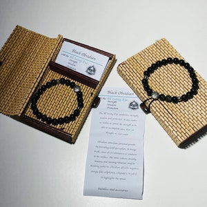 Gemstone 8mm Bracelet with Stainless Steel All Seeing Eye Bead with the description of the stone in a Beautiful Bamboo Giftbox