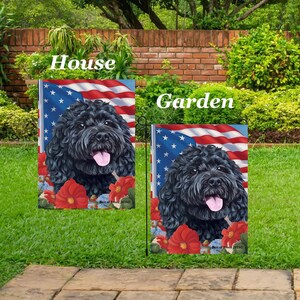May include: Two garden flags featuring a black dog with a pink tongue, set against an American flag backdrop and red flowers. The flags are labeled "House" and "Garden."