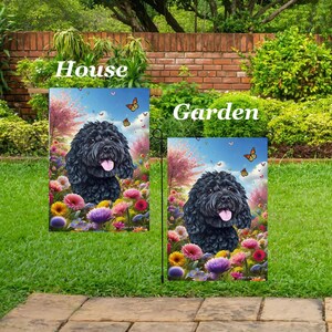 May include: Two garden flags with a black dog portrait surrounded by colorful flowers and butterflies. The flags are labeled "House" and "Garden" in white text against a green background.