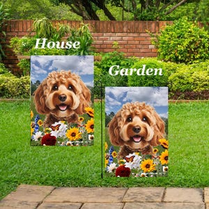 May include: Two garden flags featuring a smiling, brown-haired dog with a floral and butterfly design. The flags read "House" and "Garden" in white text against a backdrop of a brick wall and green foliage.