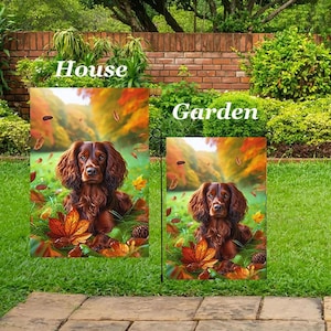 May include: Two decorative flags, one for the house and one for the garden, featuring a brown dog in a fall scene. The flags have the words "House" and "Garden" printed on them. The dog is surrounded by autumn leaves and a colorful background.