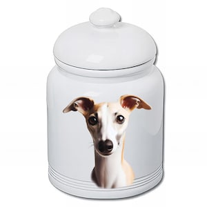 May include: White ceramic jar with a lid, featuring a detailed illustration of a Whippet dog. The dog has tan and white fur, with large, expressive eyes. The jar has black stripes around the base.