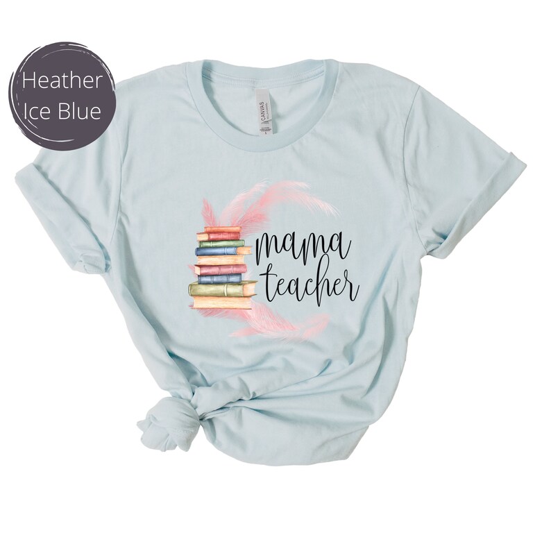 May include: Light blue t-shirt with a stack of books and pink feathers, and the text "mama teacher" printed on the front.