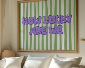 May include: A framed print with a green and white striped background and the text "HOW LUCKY ARE WE" in purple bubble letters.