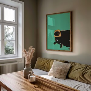 May include: A black cat with a slice of bread on its head, illustrated in a minimalist style, is featured on a green background in this poster.