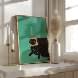 May include: A framed print of a black cat wearing a slice of bread on its head. The cat is looking to the left, and the background is a teal green colour.