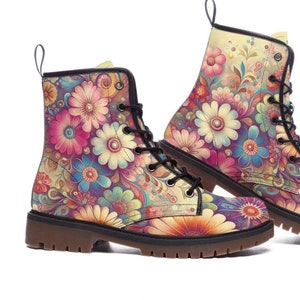 May include: A pair of floral print combat boots. The boots feature a colorful pattern of flowers in shades of pink, blue, yellow, and orange against a cream background. They have black laces and a brown sole.