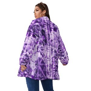 May include: A long, open-front jacket with a vibrant tie-dye pattern in shades of purple and white. The jacket has long sleeves and a relaxed fit, perfect for layering. The fabric appears soft and flowing, creating a bohemian aesthetic.