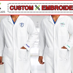 May include: Two white lab coats with custom embroidery. One coat has a blue "F" in a shield on the chest and "Frank" embroidered on the sleeve. The other coat has a green and pink tooth with "Smile Dental" embroidered on the chest and "Dr. Smith" embroidered on the sleeve.