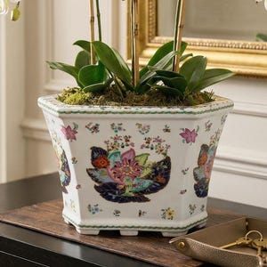 May include: A set of three ceramic mugs with a speckled, matte finish. The mugs are in shades of cream, light gray, and dark gray. Each mug has a simple, minimalist design and a rounded handle.