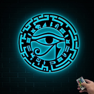 May include: A blue neon light with a circular design featuring the Eye of Horus, surrounded by hieroglyphs. The light is mounted on a brick wall and is controlled by a remote.