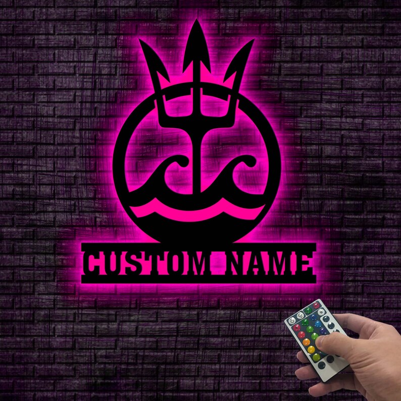 May include: A pink neon sign with a trident and waves in a circle, with the text "CUSTOM NAME" below. The sign is mounted on a brick wall and a remote control is visible in the bottom right corner.