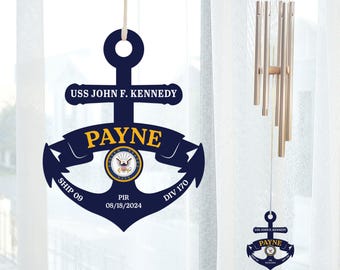 May include: A blue wooden anchor with the text "USS JOHN F. KENNEDY" and "PAYNE" on it. The anchor also has the text "SHIP 09", "PIR 08/18/2024", and "DIV 170".