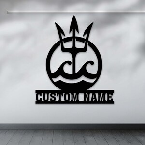 May include: Black metal wall decor featuring a trident with waves in a circle, with the text "CUSTOM NAME" below.