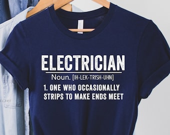 May include: Navy blue t-shirt with white text that reads "ELECTRICIAN Noun. [IH-LEK-TRISH-UHN] 1. ONE WHO OCCASIONALLY STRIPS TO MAKE ENDS MEET"