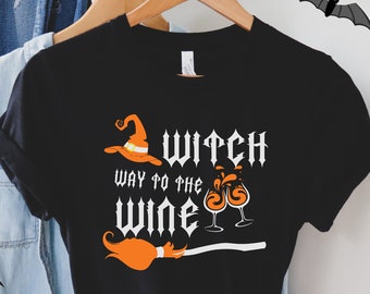 May include: Black t-shirt with a white graphic that says "Witch Way to the Wine" with a witch's hat, broom, and wine glasses.