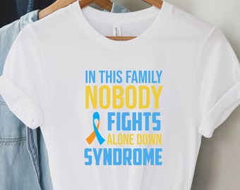 May include: White t-shirt with a blue and orange ribbon and the text "In this family nobody fights alone down syndrome".