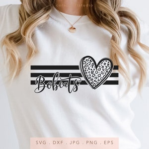 May include: White t-shirt with black stripes and a leopard print heart. The text "Bobcats" is written in black cursive lettering.