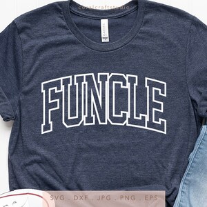 May include: A navy blue t-shirt with the word "FUNCLE" printed in white with a black outline. The word is in a large, bold font and is centered on the shirt.