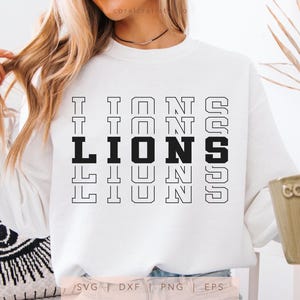 May include: White sweatshirt with black text that reads "LIONS" repeated in a stacked pattern. The text is outlined in black.