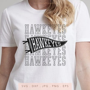 May include: White t-shirt with a black and white graphic of a pennant with the word "HAWKEYES" repeated multiple times.