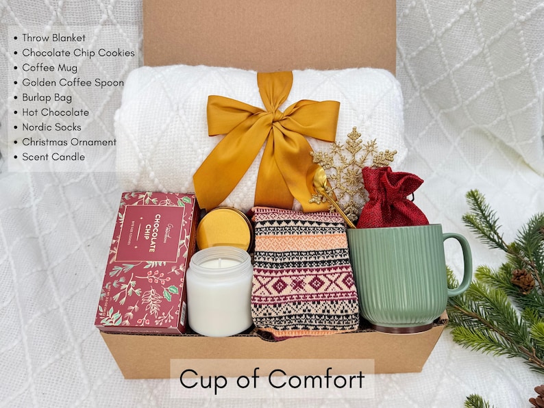 Holiday care package with mug, candle, socks and cozy blanket for winter self-care