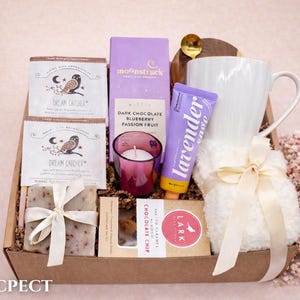 Wellness gift box for women with natural skincare and a warm cozy blanket.
